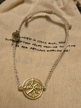 Pura Vida Gold Compass Pendant on Cream Braided Cord Bracelet
